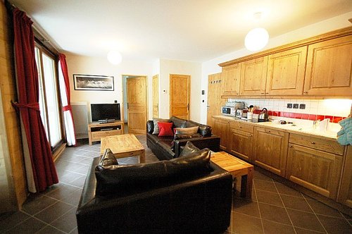 Open plan living area with glass doors onto balcony