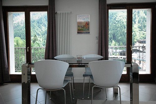 Dining area with glass doors leading onto balcony
