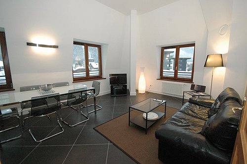 Open plan living and dining area with double height ceilings