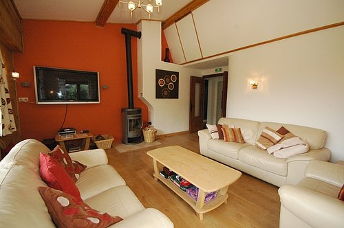 Living room on first floor with wood burner