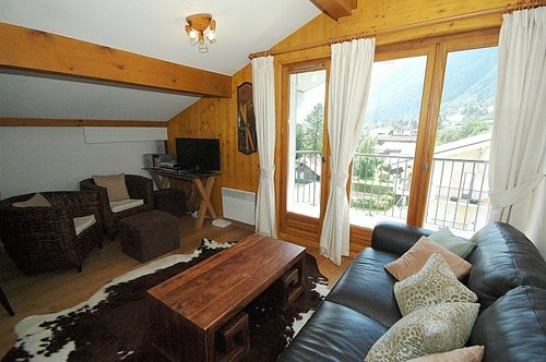 Open plan living area with glass doors onto balcony