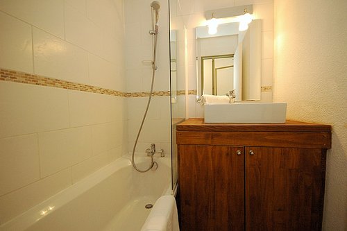 Bathroom with washing machine under the basin