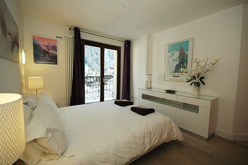 Double bedroom with glass doors onto balcony