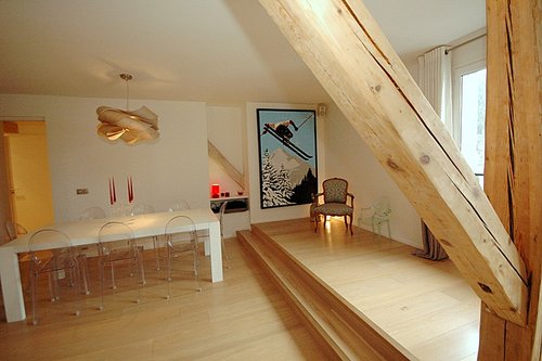 Original beams contrast with modern interior