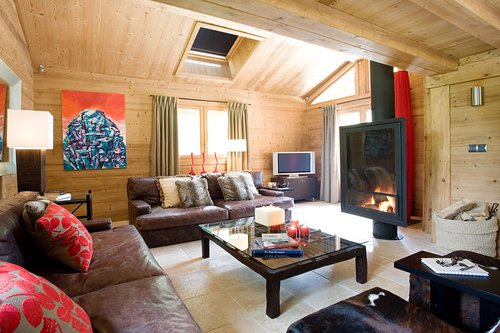 Living area with wood burning stove and French doors leading onto terrace