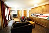Open plan living area with glass doors onto balcony