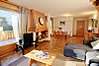 Living area with log burner and glass doors to terrace
