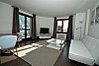 Open plan living area with glass doors onto balcony