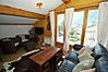 Open plan living area with glass doors onto balcony